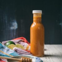 chipotle dressing in a bottle with blue background