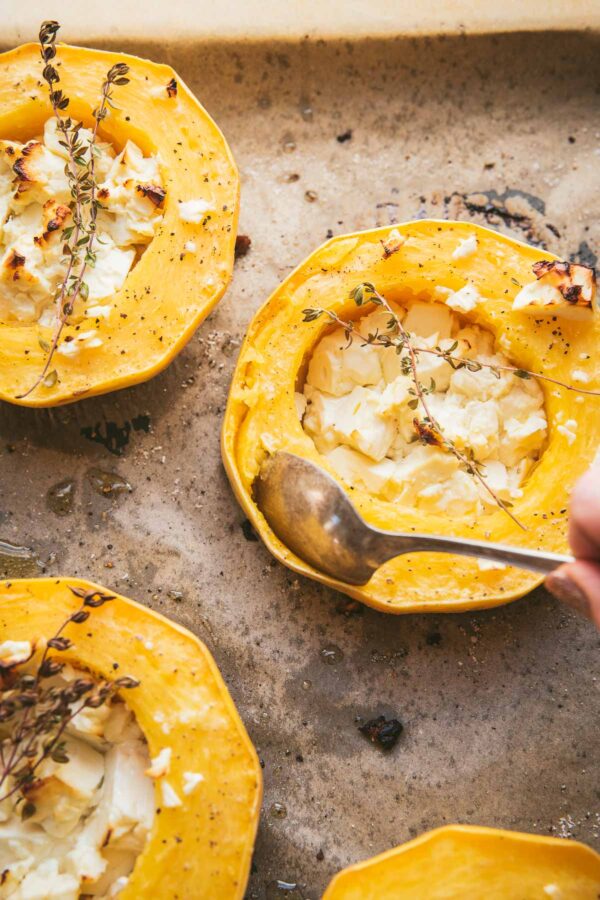 spoon scooping squash from rind