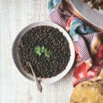 overhead of black beans in a bowl with cilantro on top