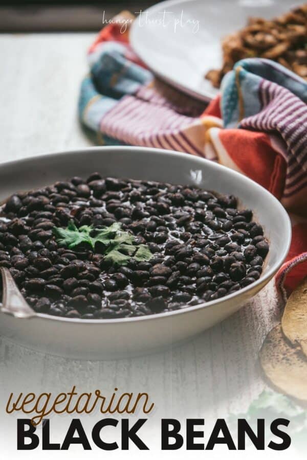 side angle of beans in a low bowl with a serving spoon