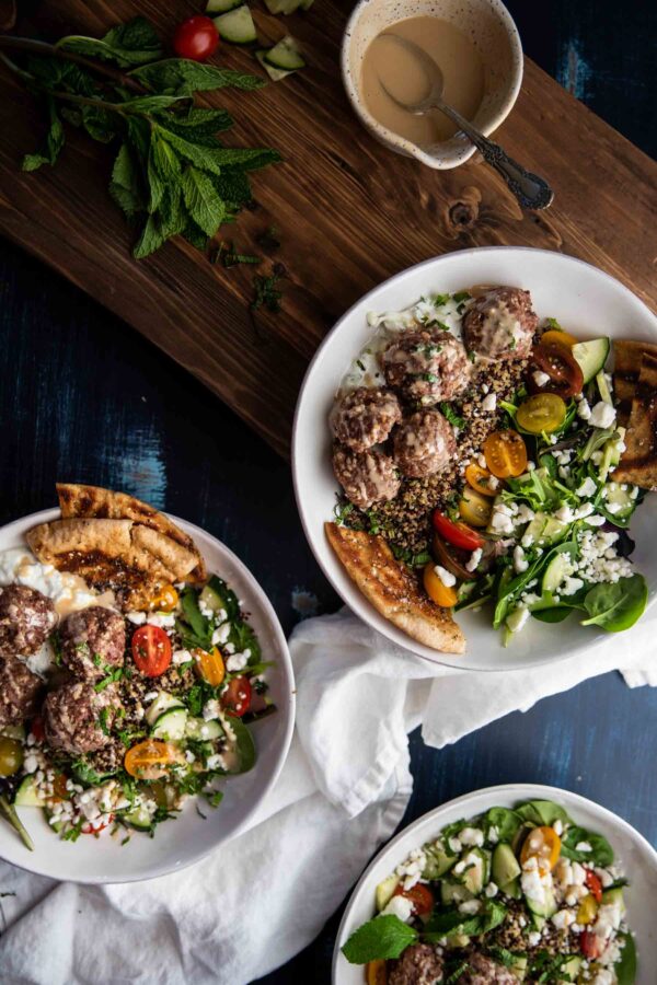 overhead photo of mediterranean quinoa bowls with meatballs