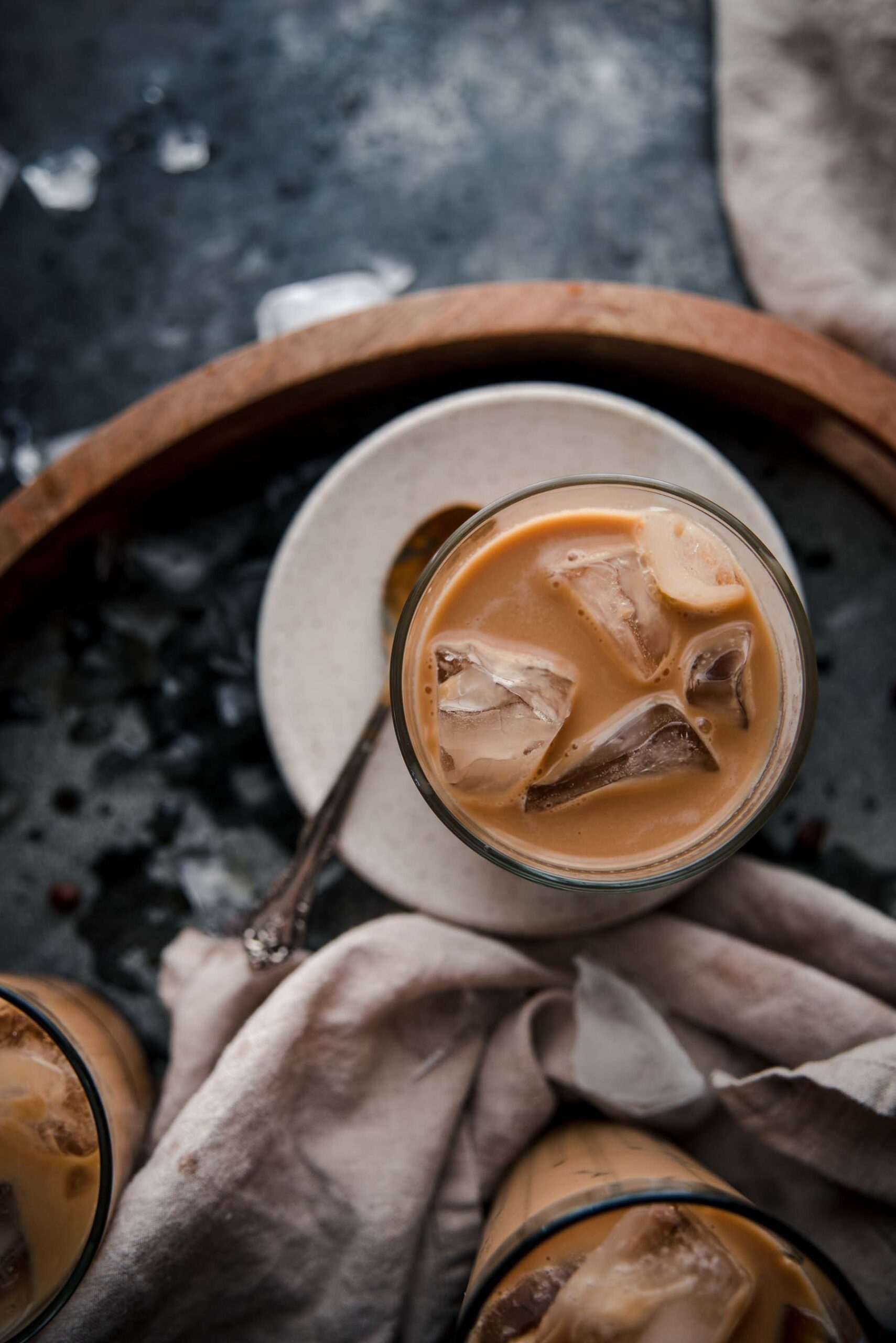 close up overhead of coffee in a glass with ice cubes