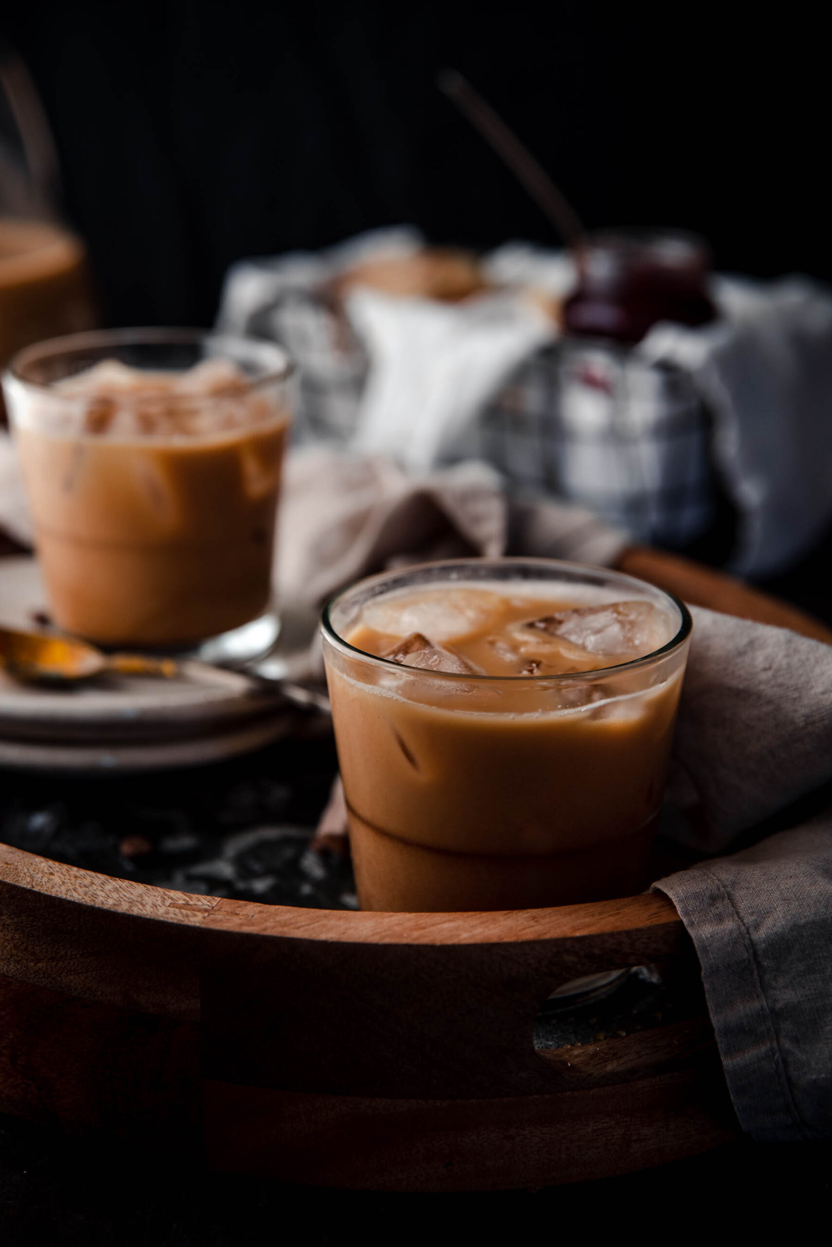 close up of coffee mixed with condensed milk in a glass with ice