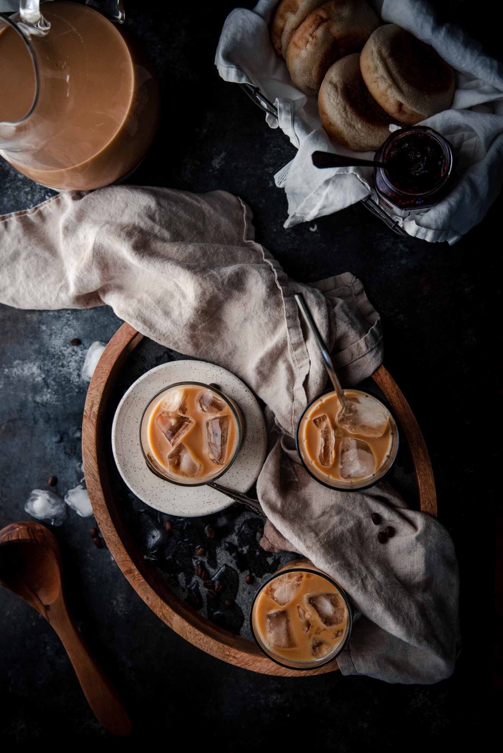 overhead of iced coffee in glasses on a serving tray with linen napkin