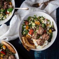 close up overhead photo of quinoa bowls with meatballs