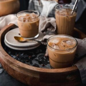 side angle of vietnamese cold brew in glasses with ice on a serving tray