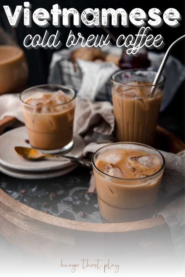 side angle of iced coffee in glasses with ice on a serving tray