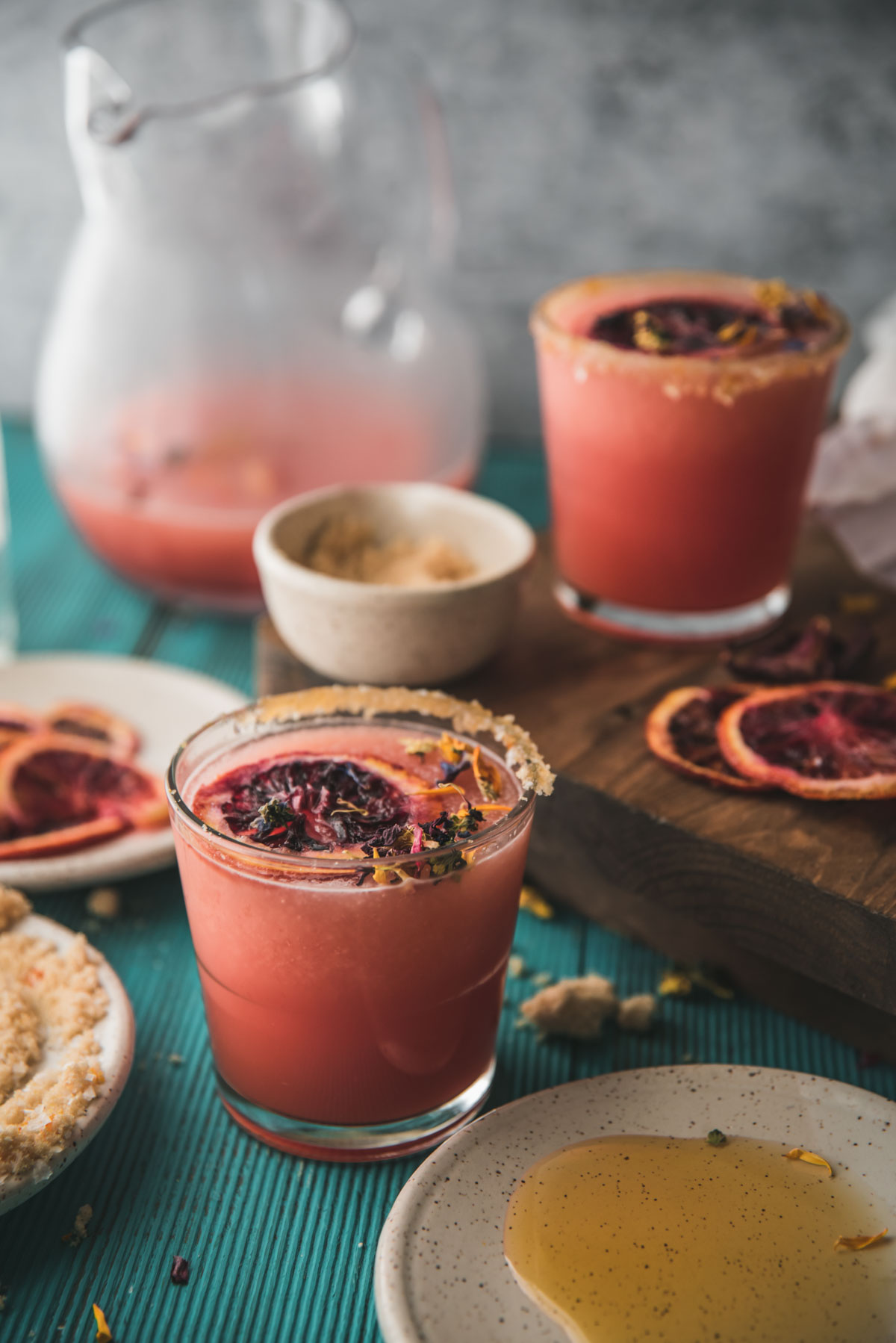 side angle of frozen cocktails in a glass with dried flower garnish