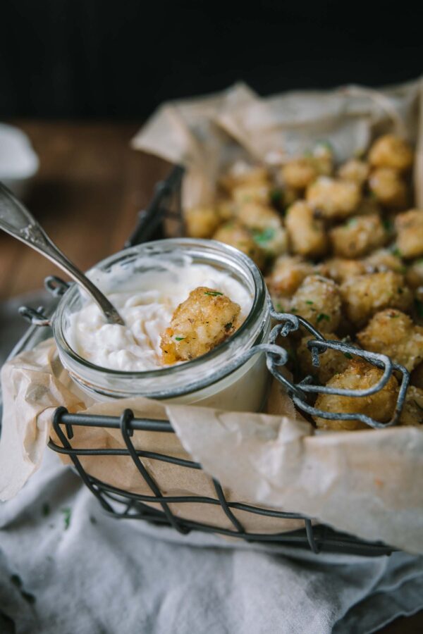 side angle of tater tot dipped in garlic aioli