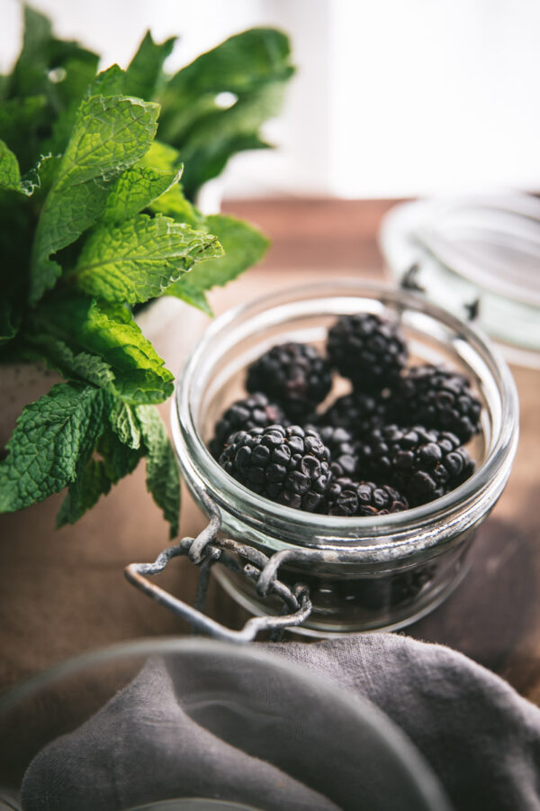 close up of fresh blackberries in a jar