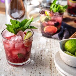 side angle of blackbery mojito in a glass