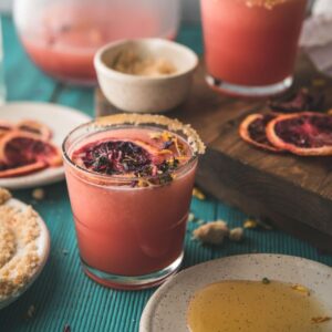 side angle of frozen blood orange margarita in a glass