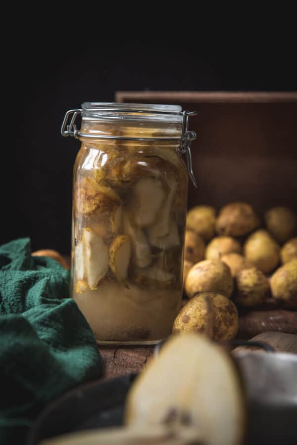 infusing vodka with pears in a large canning jar