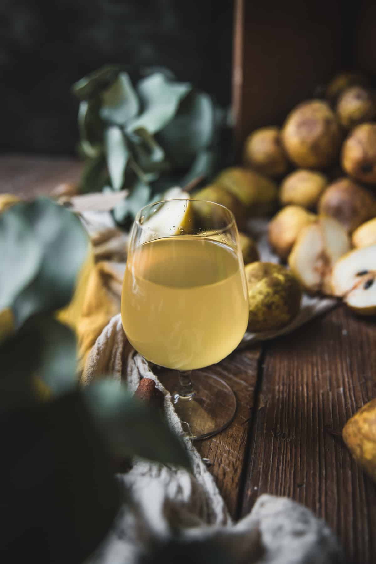 pear liqueur in a cordial glass on wooden surface