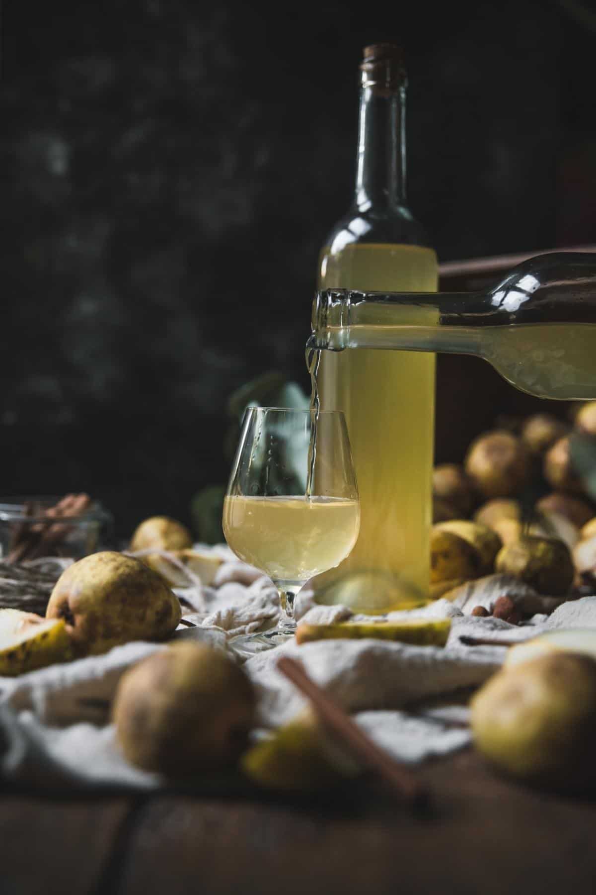 pouring fruit infused liquor into a cordial glass