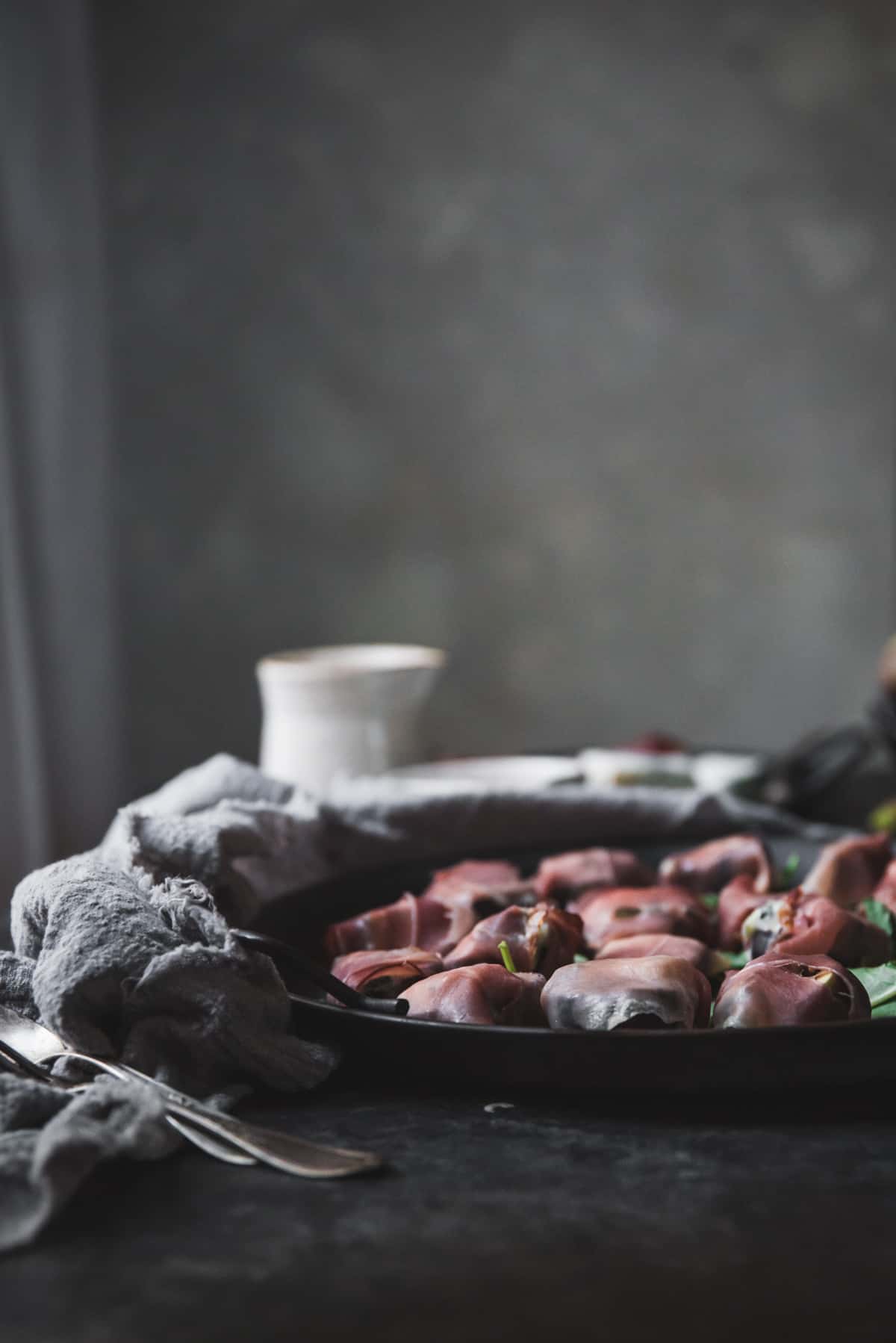 prosciutto wrapped figs on a tray waiting to be baked