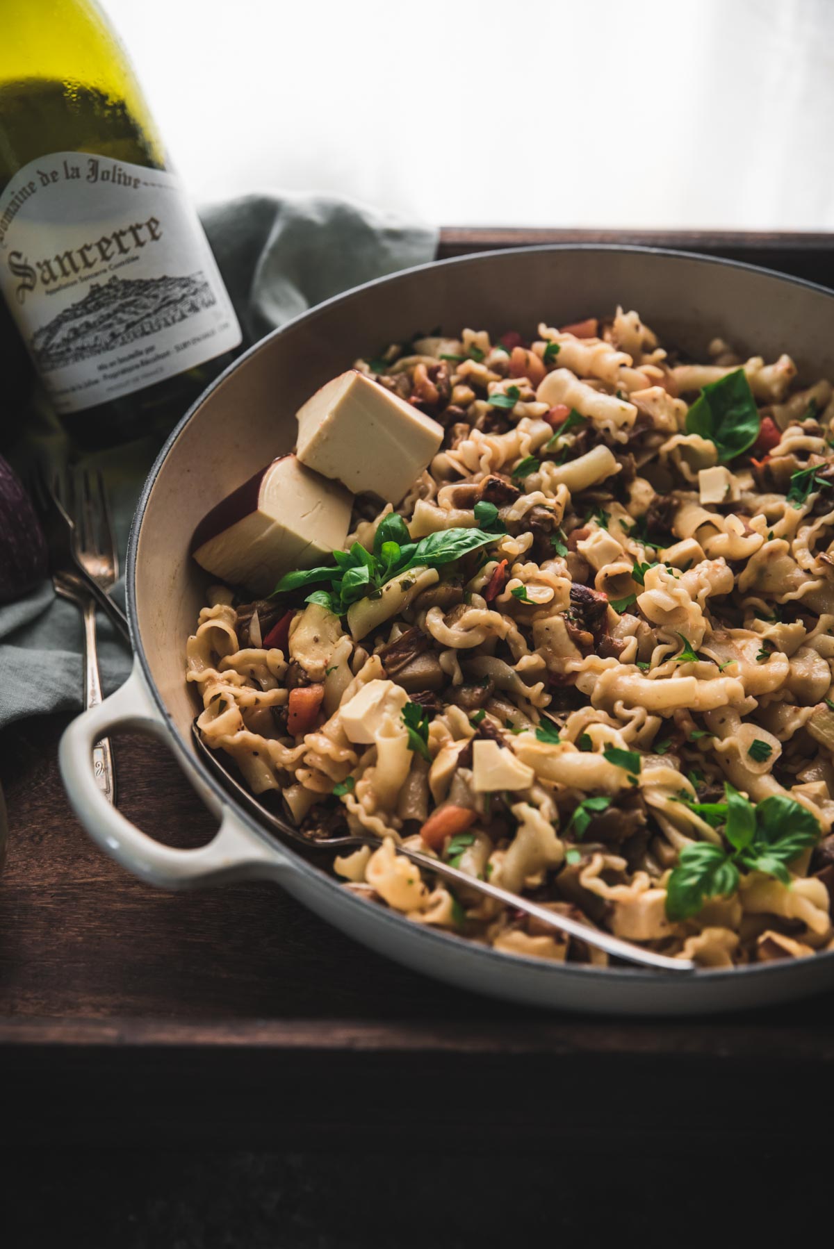 backlit photo of pasta in a large braiser dish