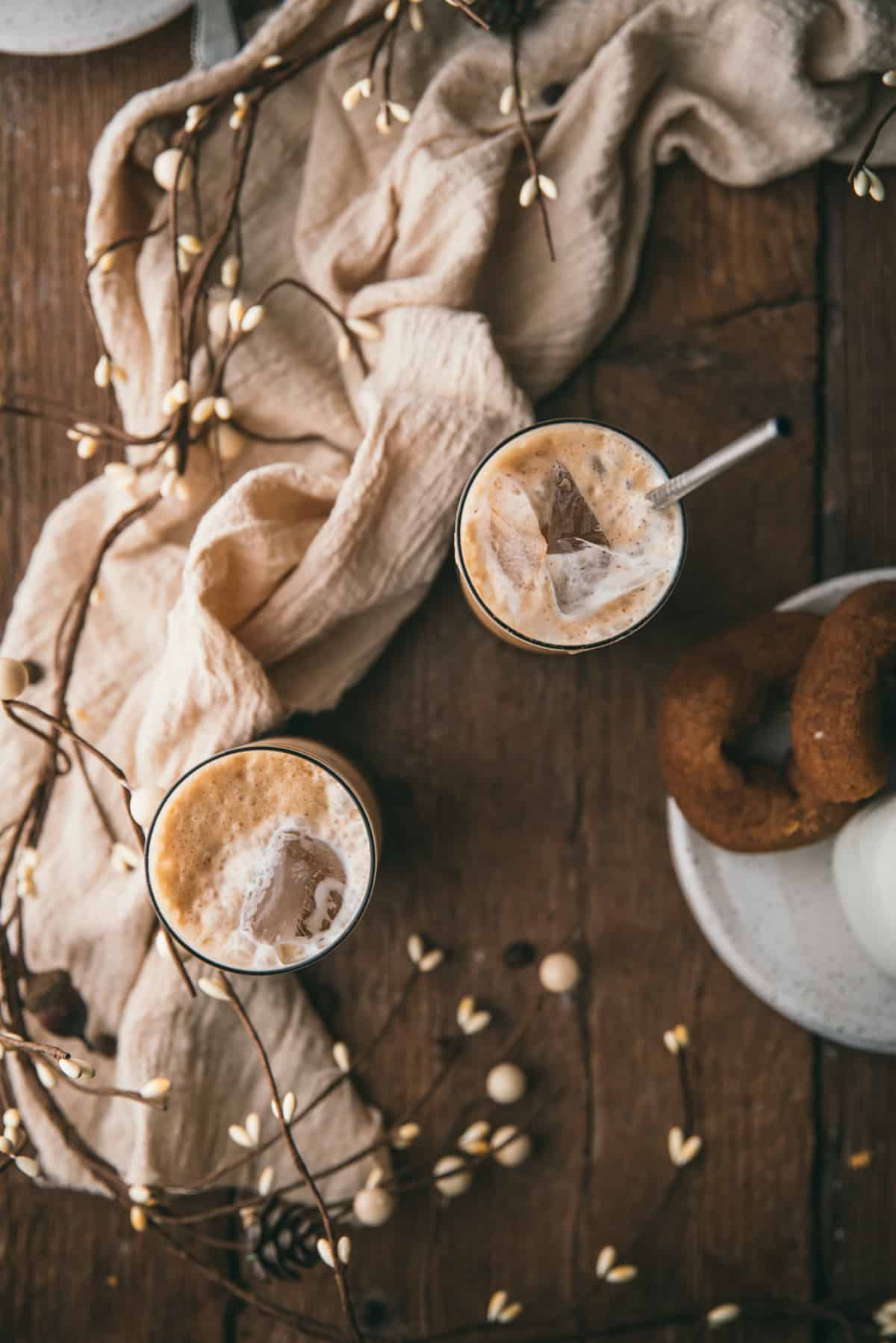 overhead of two glasses filled with iced latte