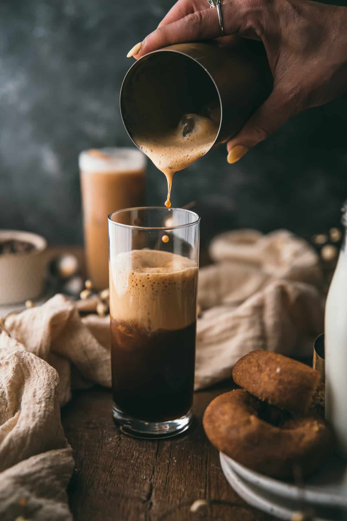 pouring foamy espresso into a glass