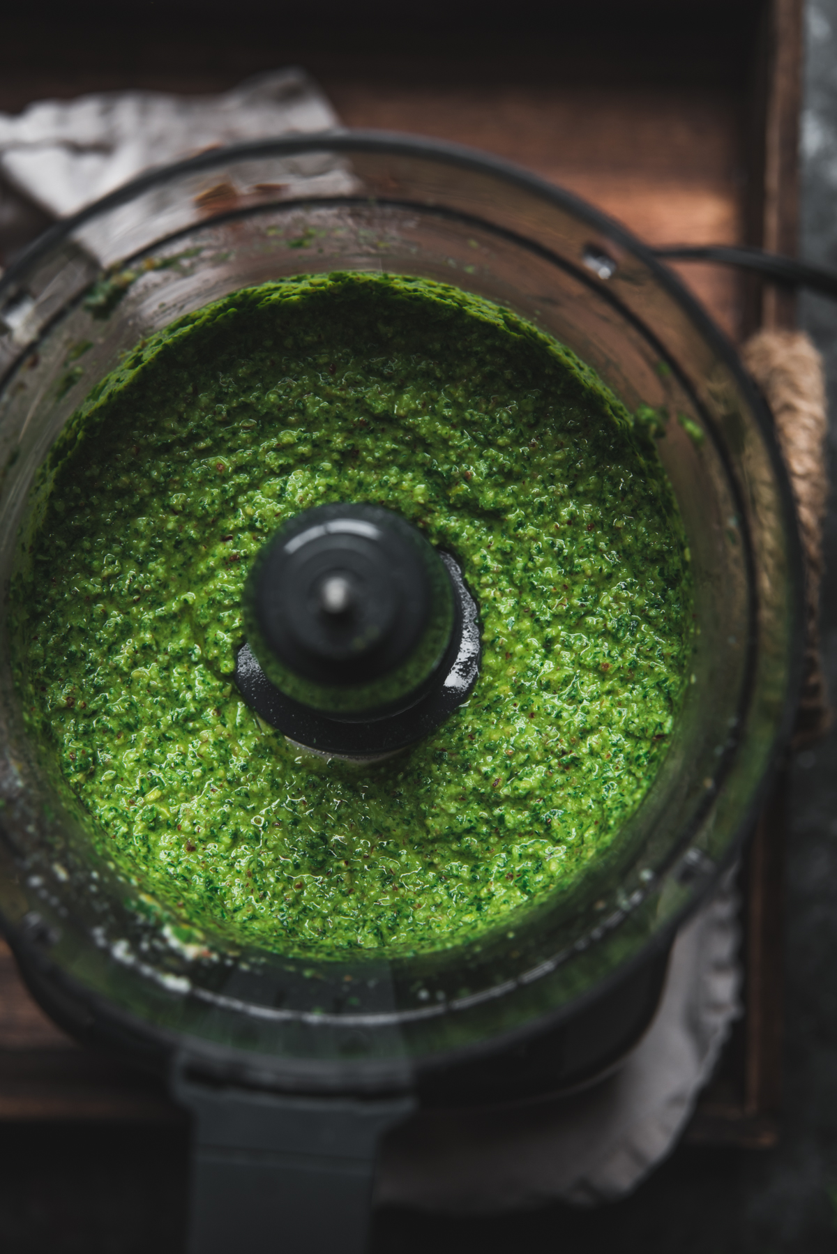 overhead of pesto blended in a food processor