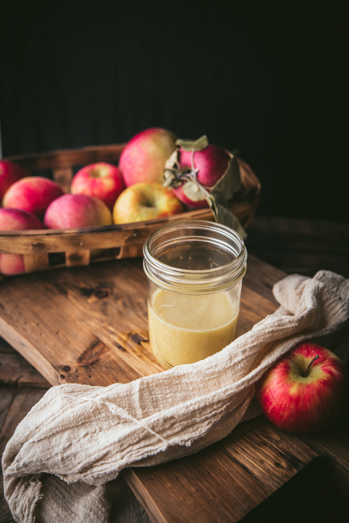 dressing in a mason jar with apples on a board