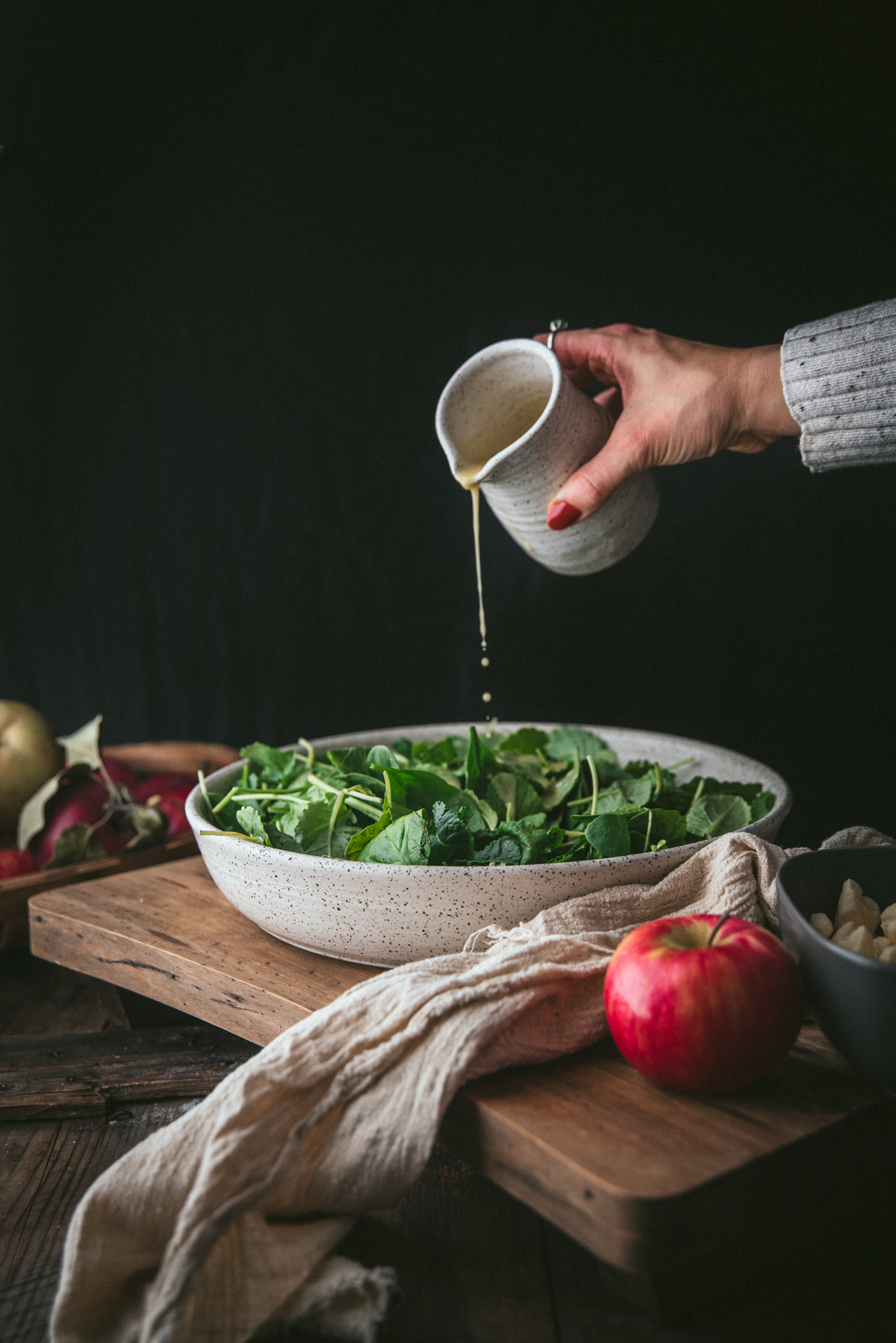 dressing pouring over salad greens