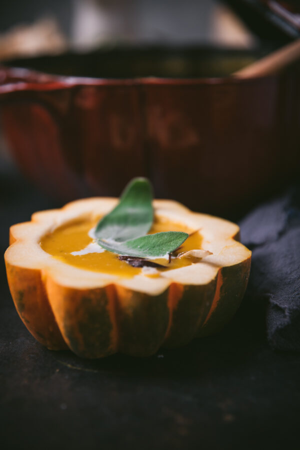 close up of soup served in an acorn squash