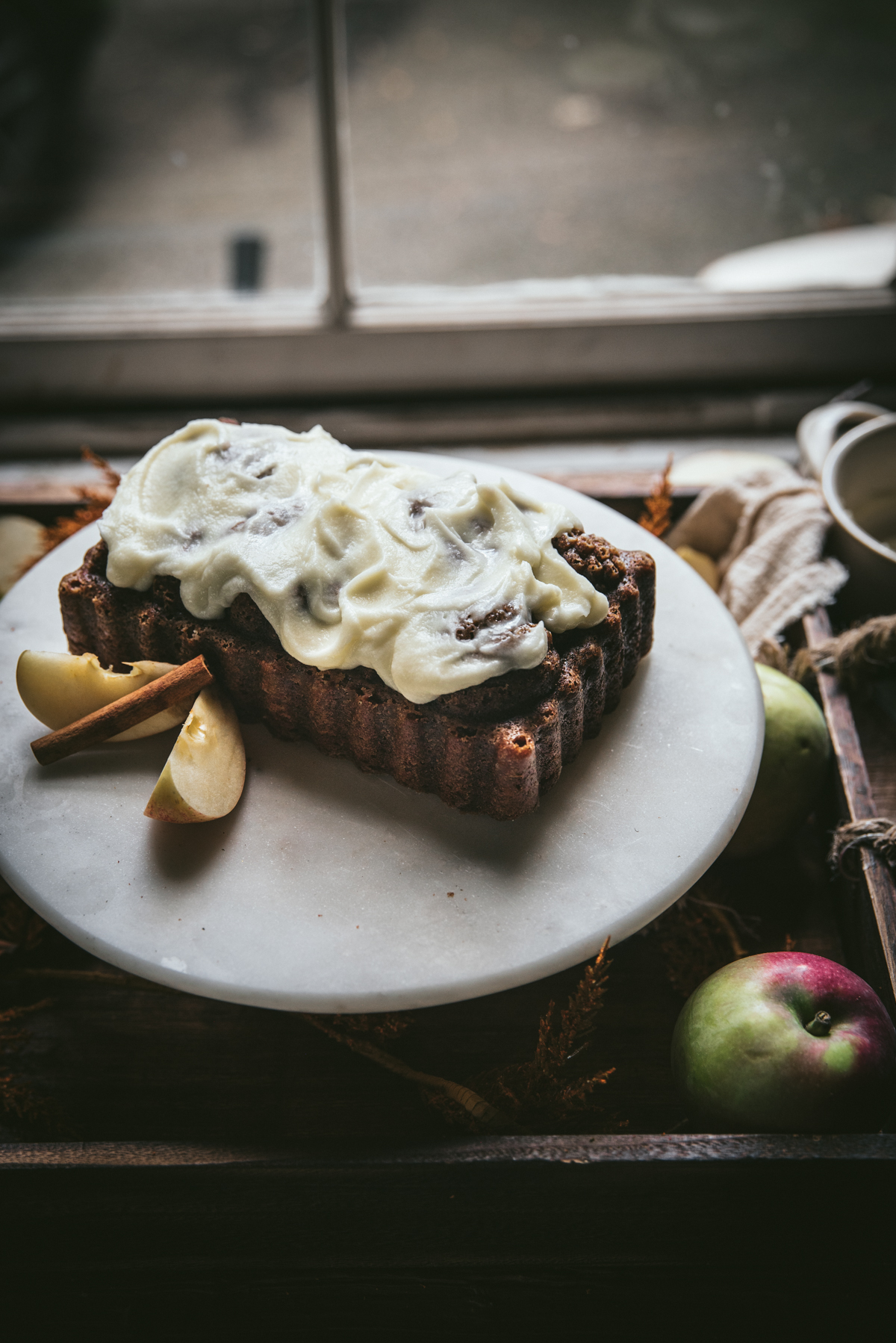 backlit side angle of apple bread with mascarpone glaze