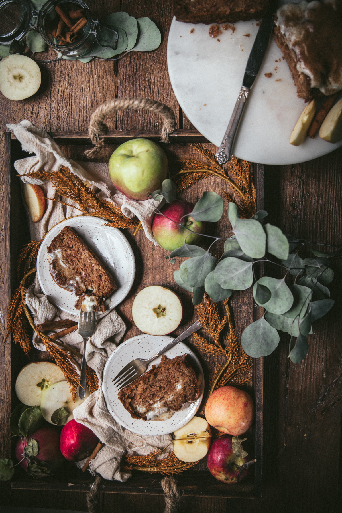 overhead of slices of apple bread on a tray with whole apples