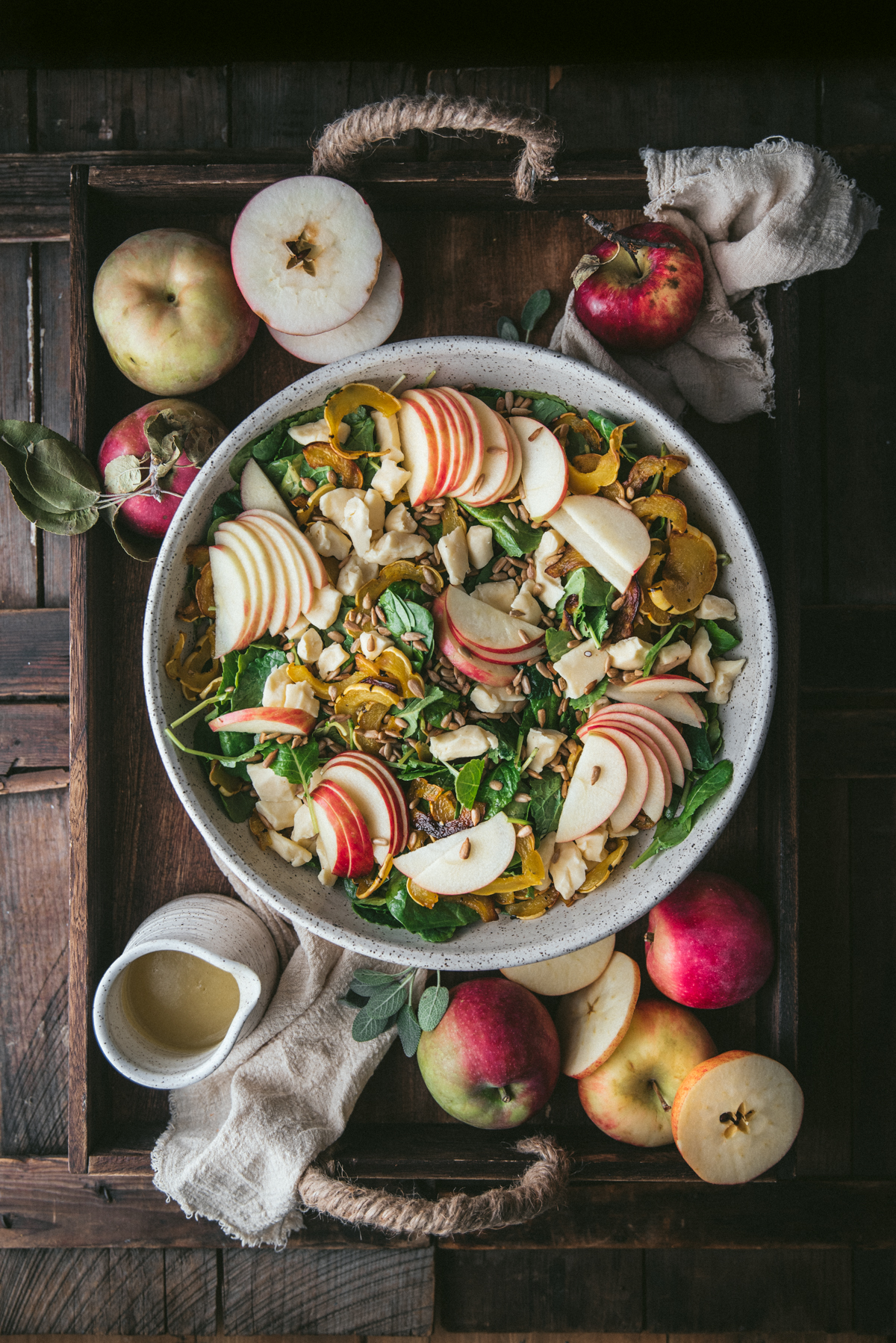 overhead of salad platter with sliced apples and roasted squash