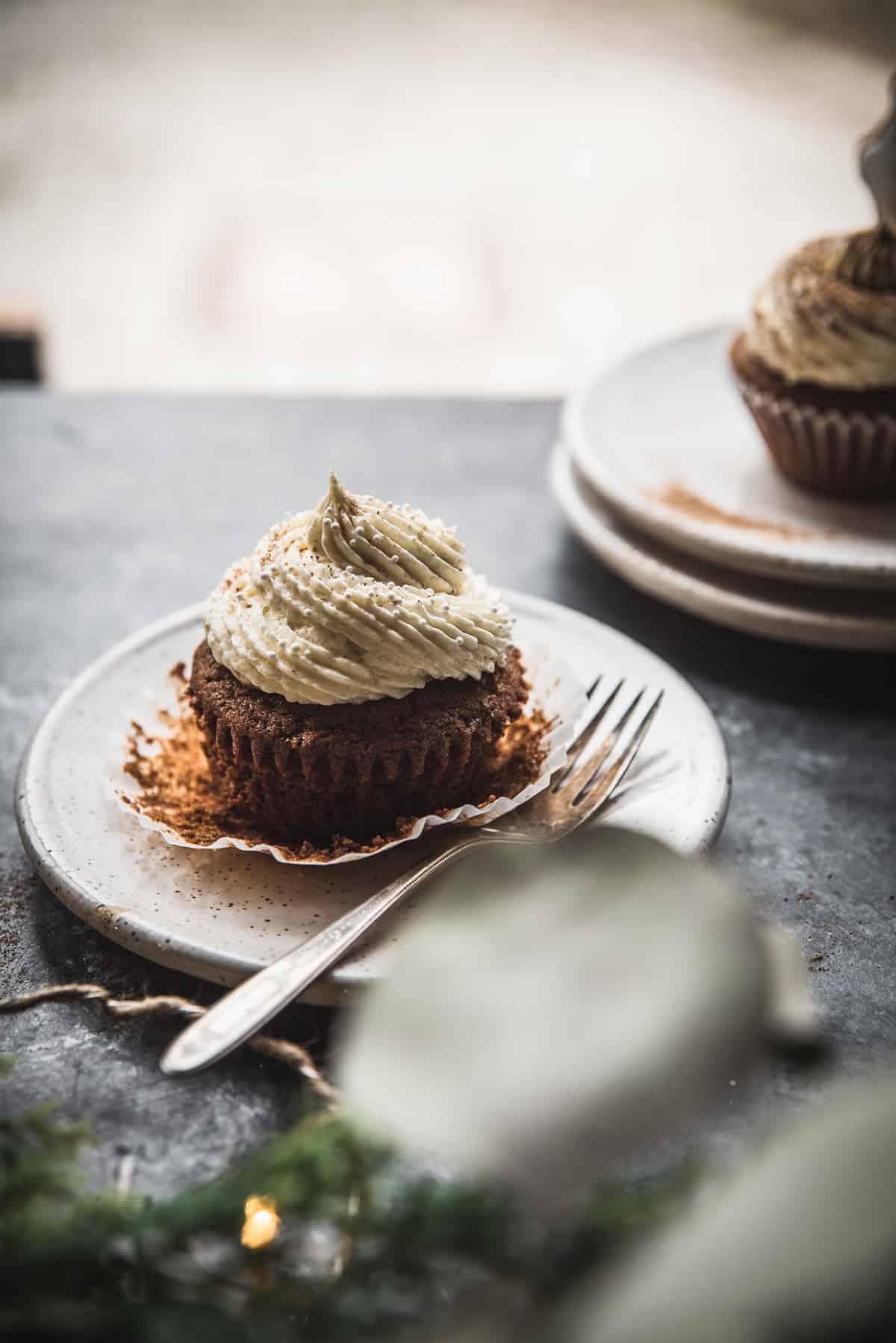 backlit photo of a cupcake on a plate with a fork
