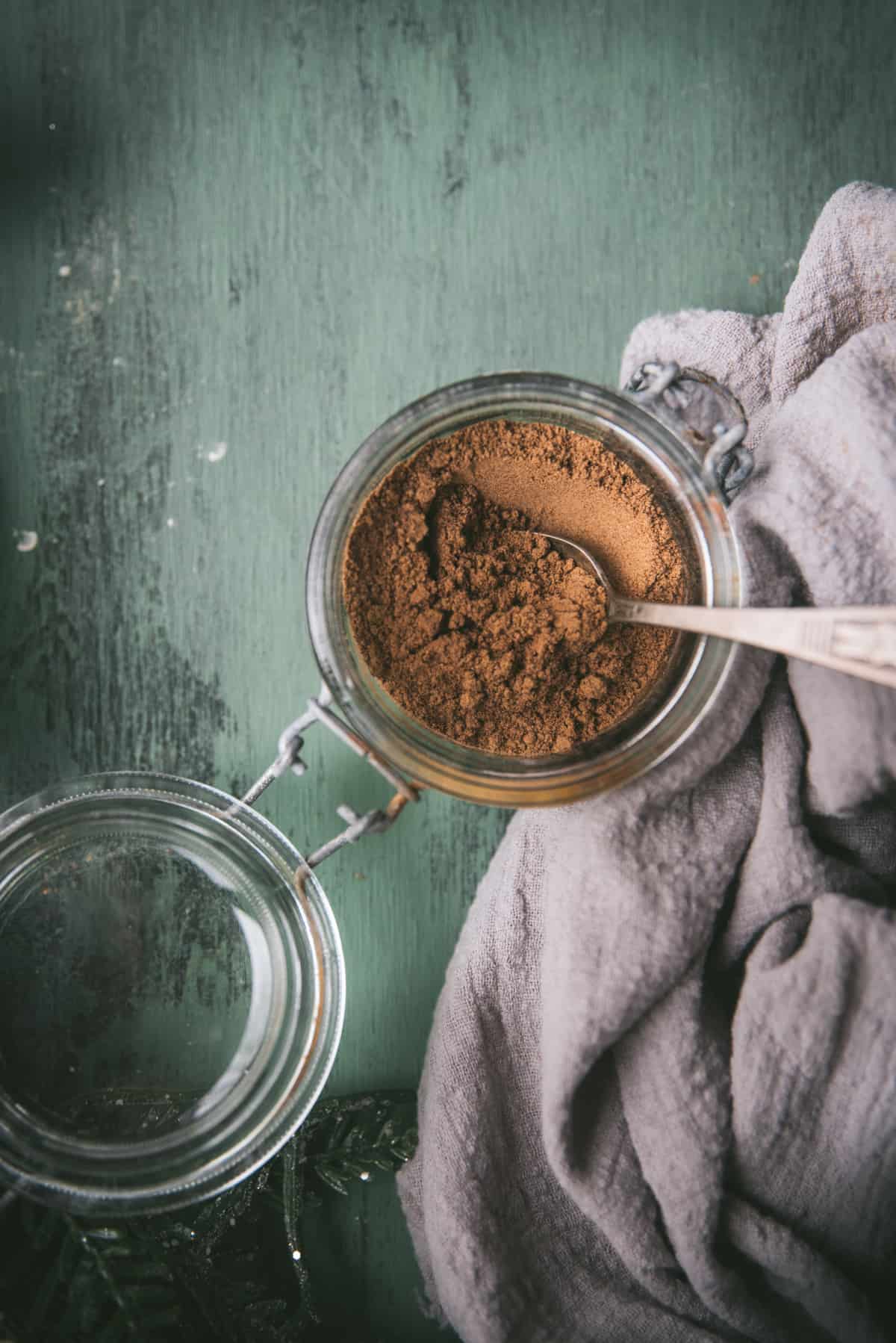 spices in a glass jar with spoon