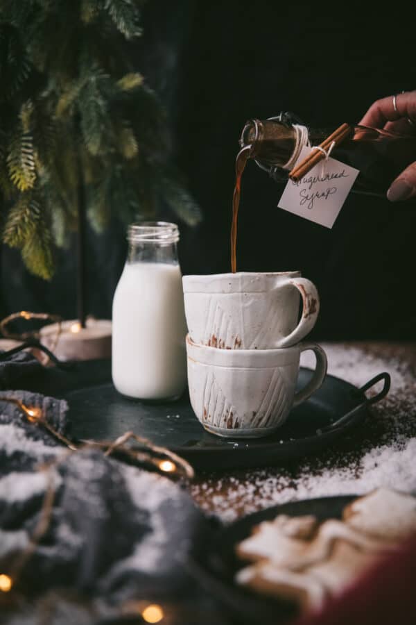 pouring gingerbread syrup into a coffee cup