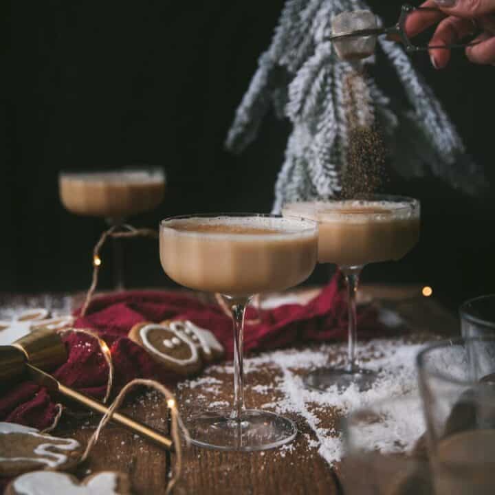 gingerbread martini in glass with spice being sprinkled over the top