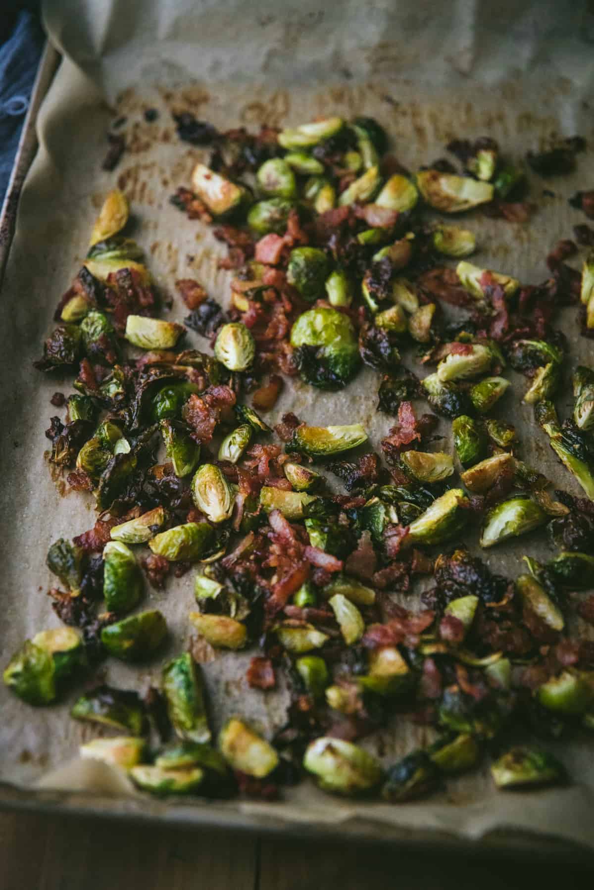 roasted vegetables with bacon on a sheet pan