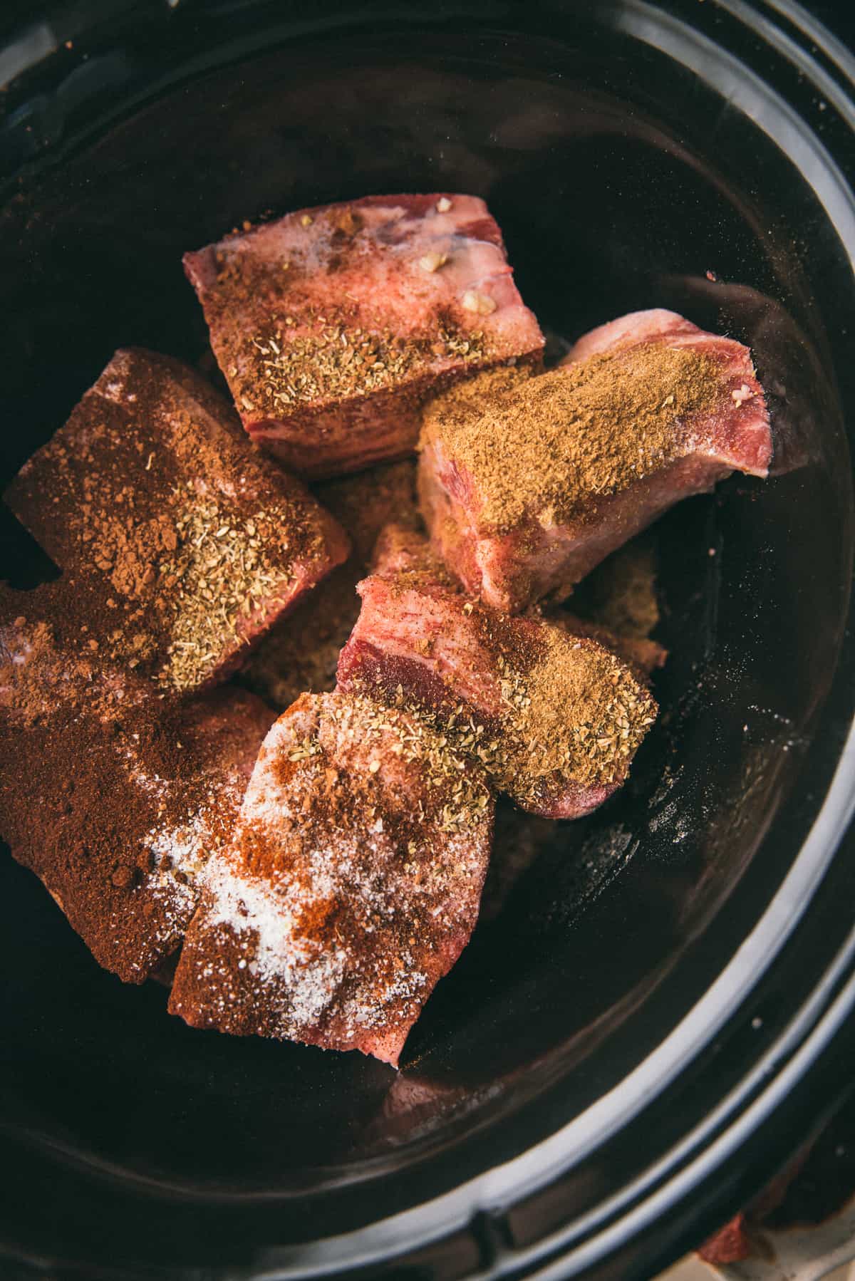 seasoned ribs in a crock pot before cooking