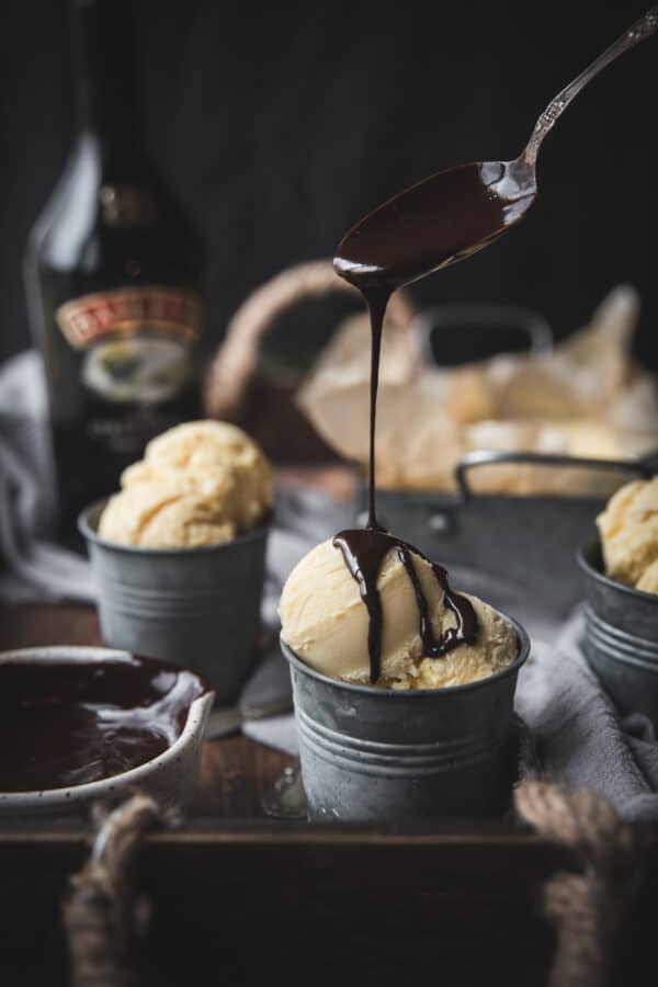 dripping guinness chocolate sauce over scoops of ice cream