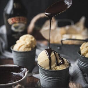 dripping guinness chocolate sauce over scoops of ice cream