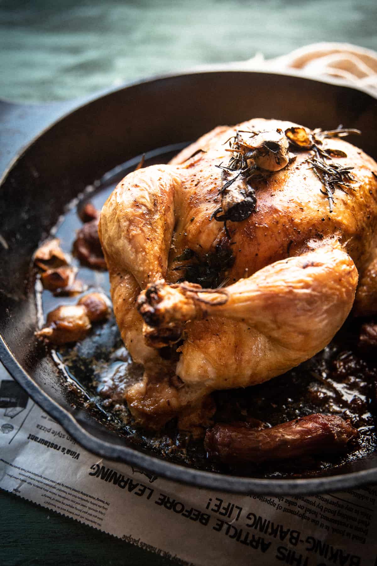 roasted whole chicken after cooking in a cast iron pan