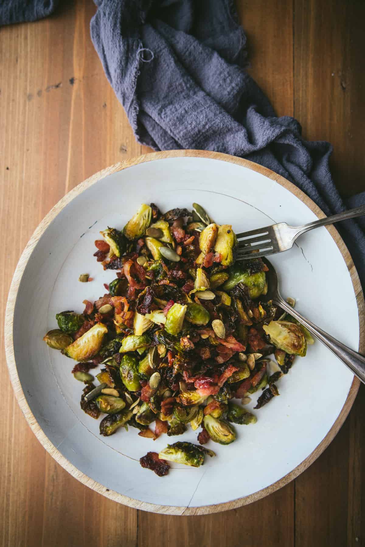 overhead angle of roasted brussels sprouts on a white platter