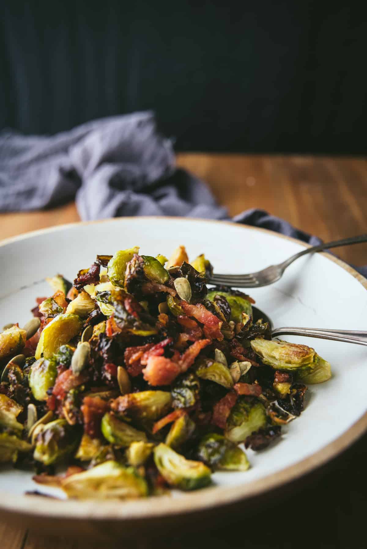 fork piercing roasted brussels sprout on platter