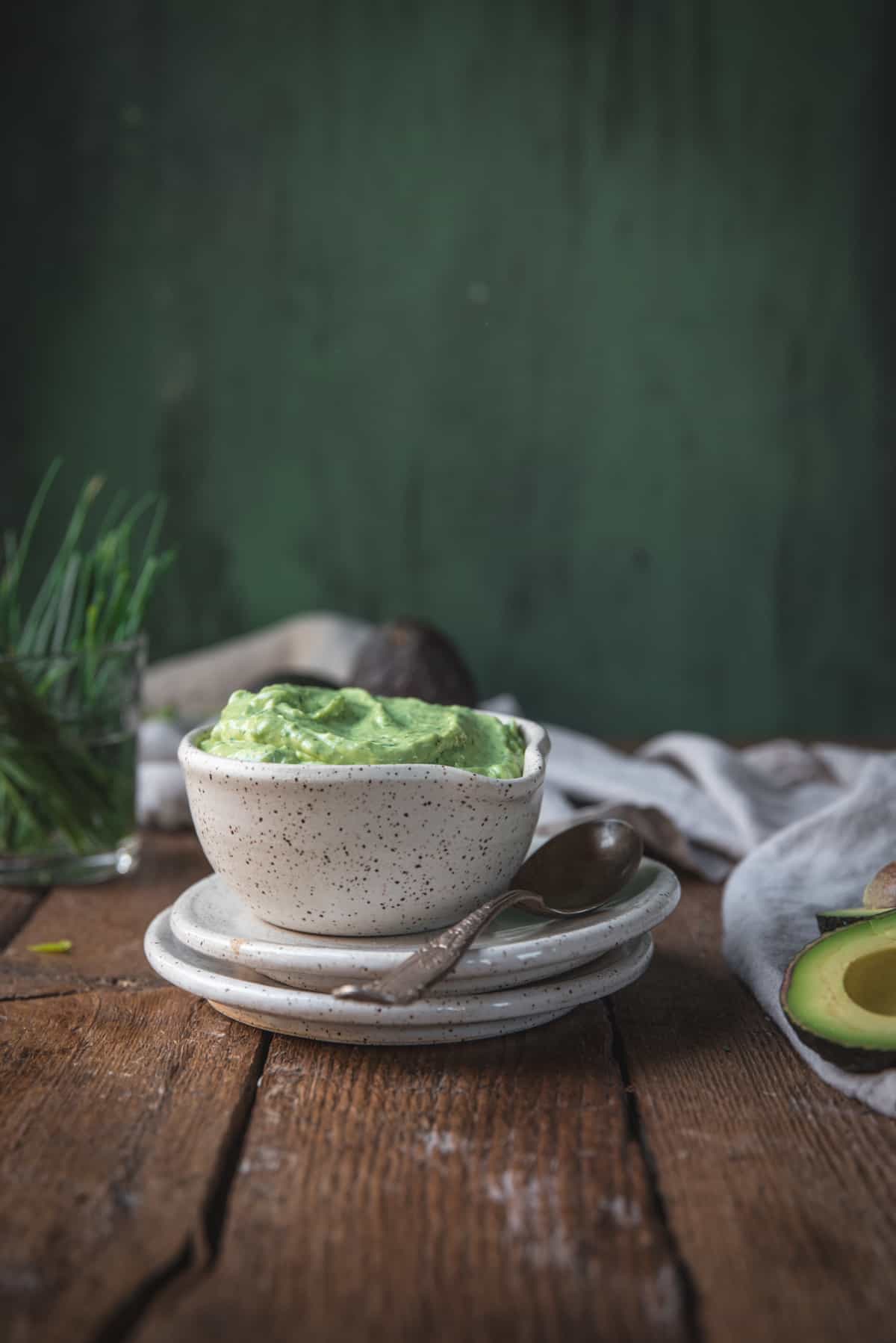 side angle of creamy green goddess dressing in a bowl
