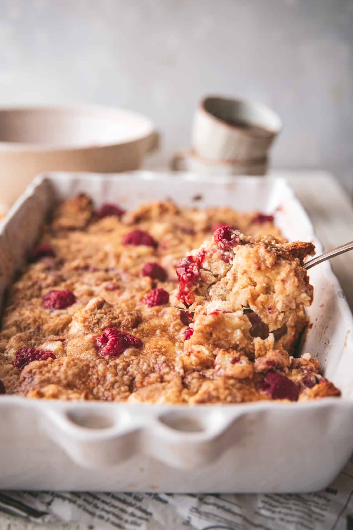 scooping stuffed french toast out of a casserole dish