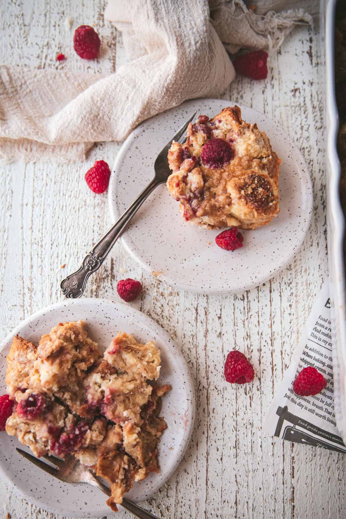 pieces of french toast bake with raspberries on plates