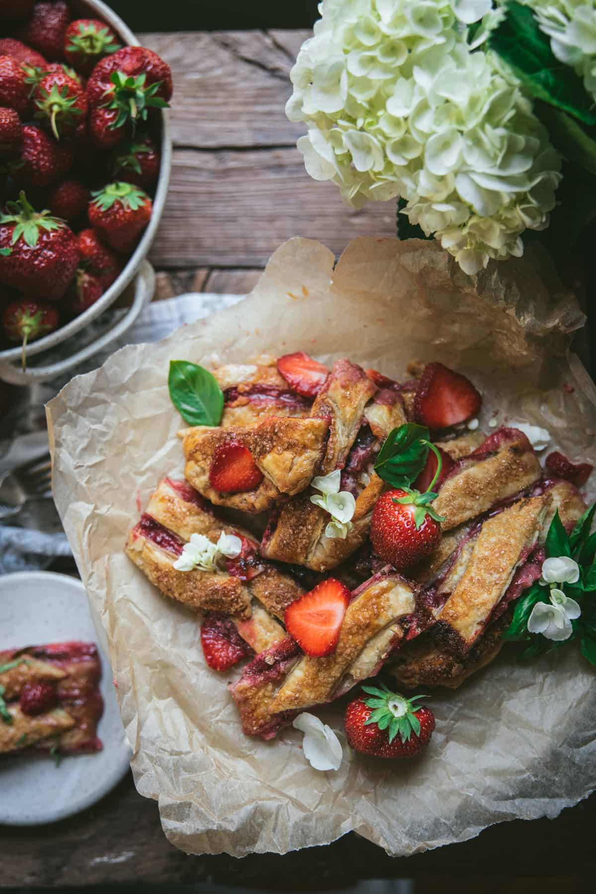 cut slices of strawberry pastry on parchment paper