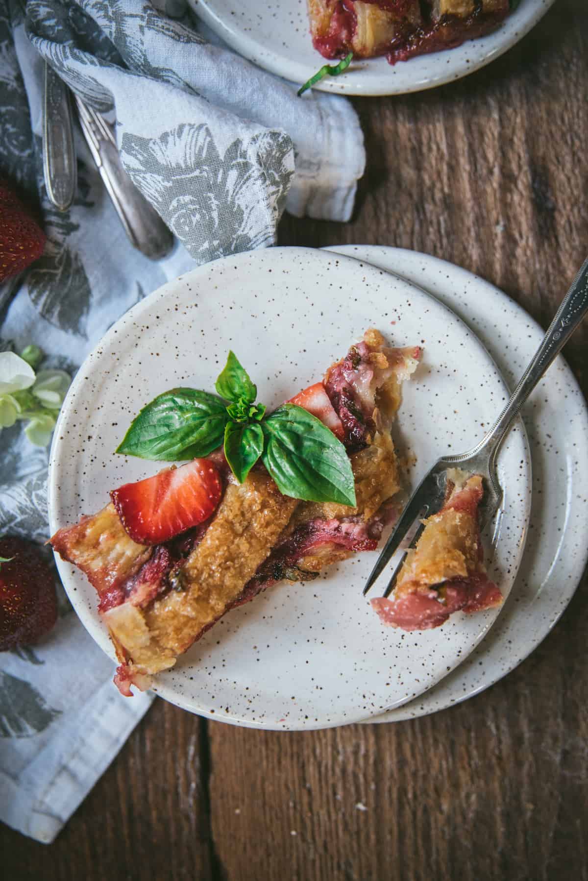 fork taking a piece out of pastry on a speckled plate