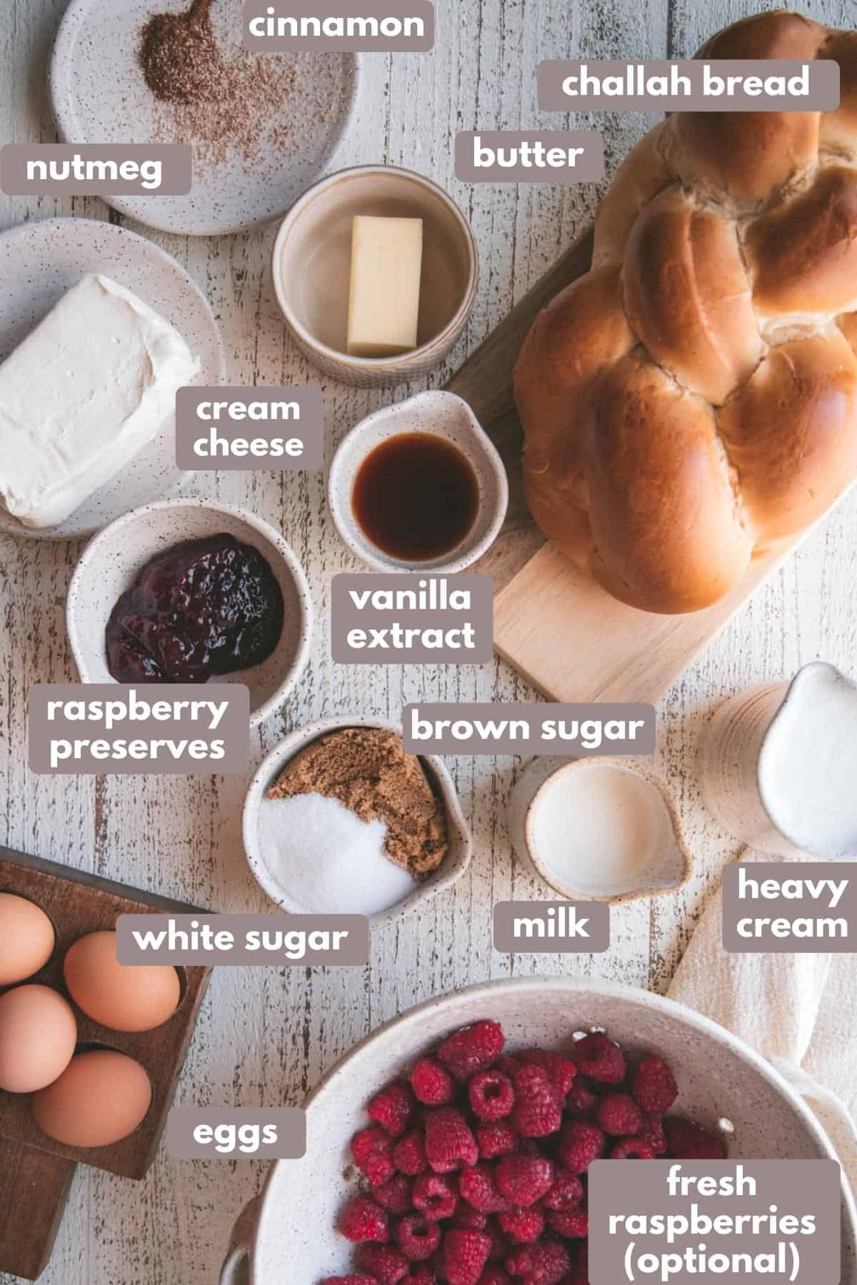 labelled ingredients for raspberry cheesecake french toast bake on a white background