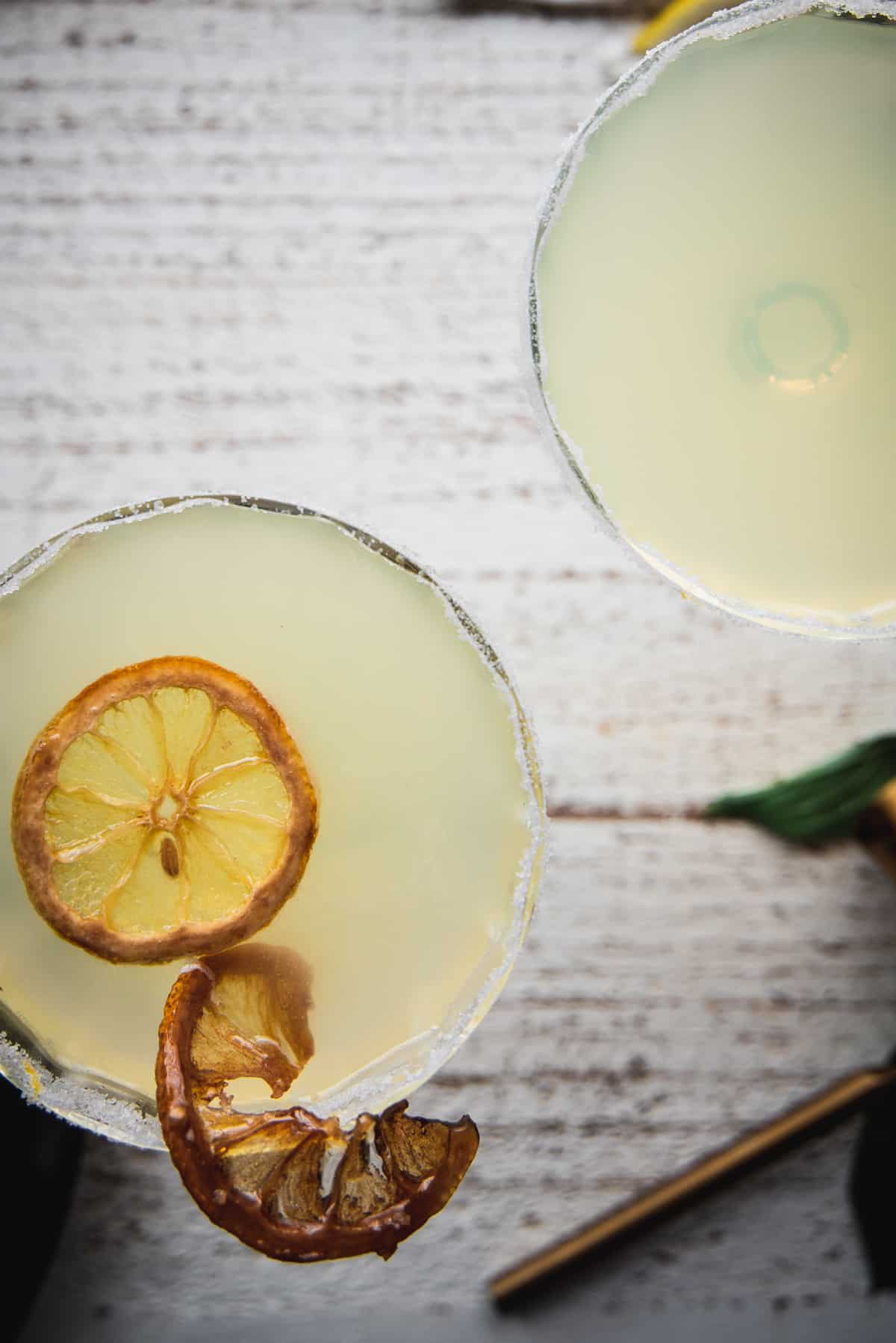 overhead photo of limoncello martinis with sugared lemon wheel garnish