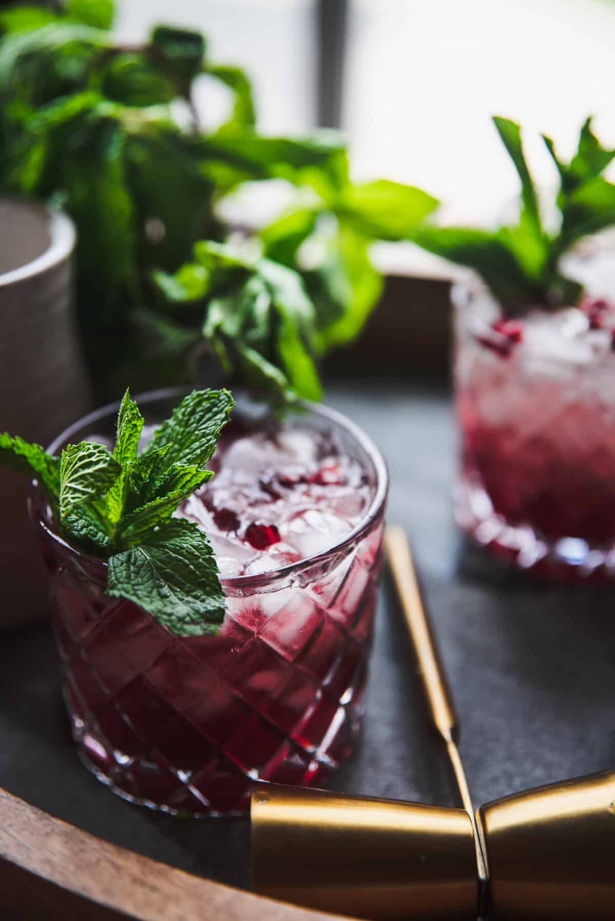 backlit photos of crushed ice topped cocktails on a drink tray