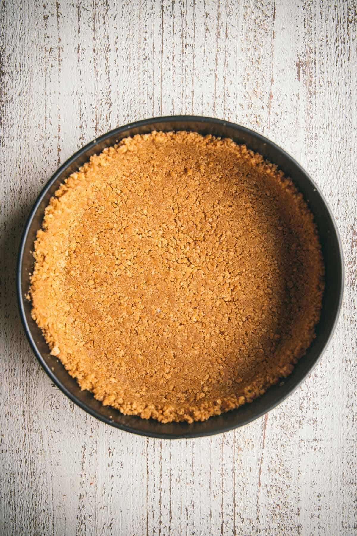 baked graham cracker crust in a springform pan